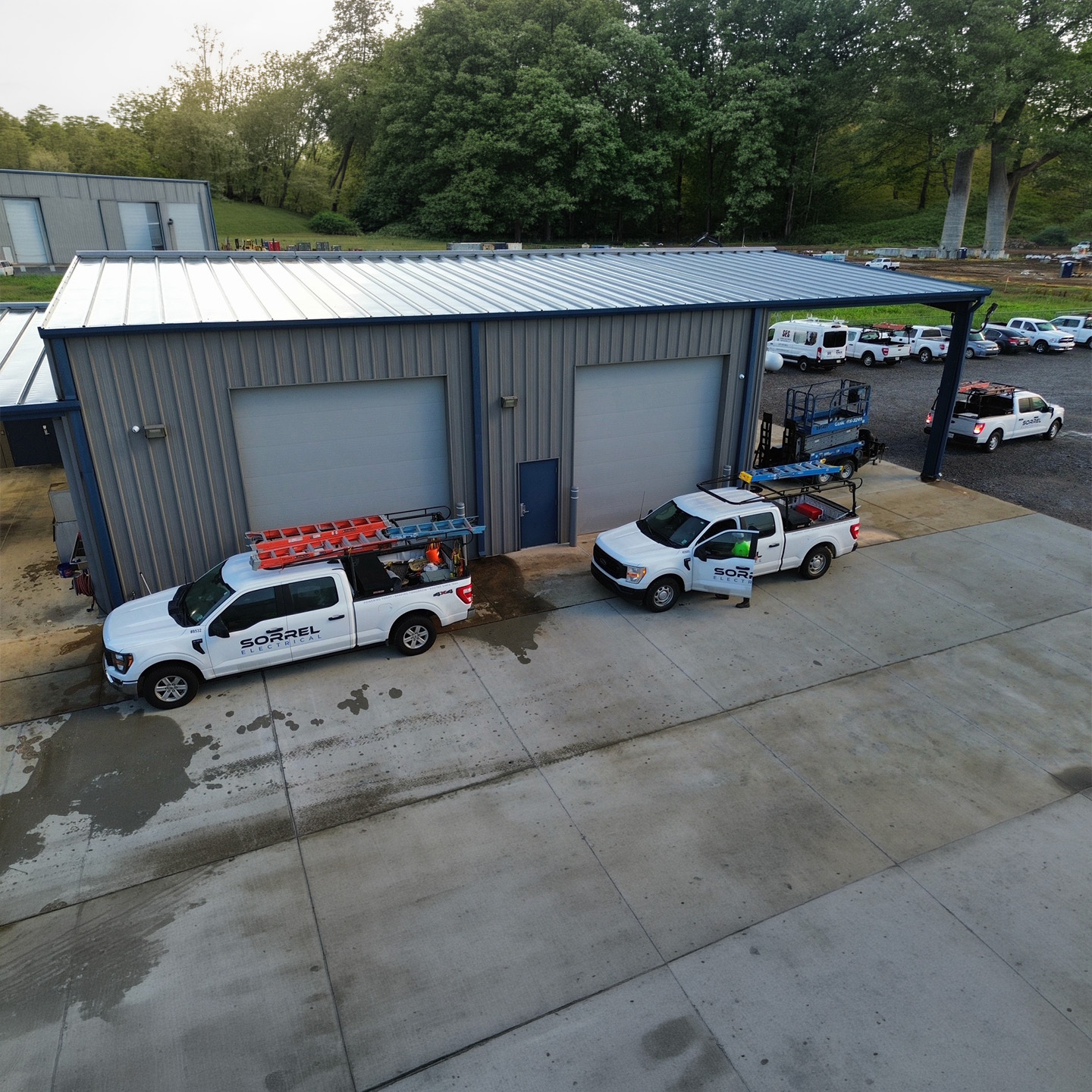 Aerial view of Sorrel Electrical service trucks outside the company facility.